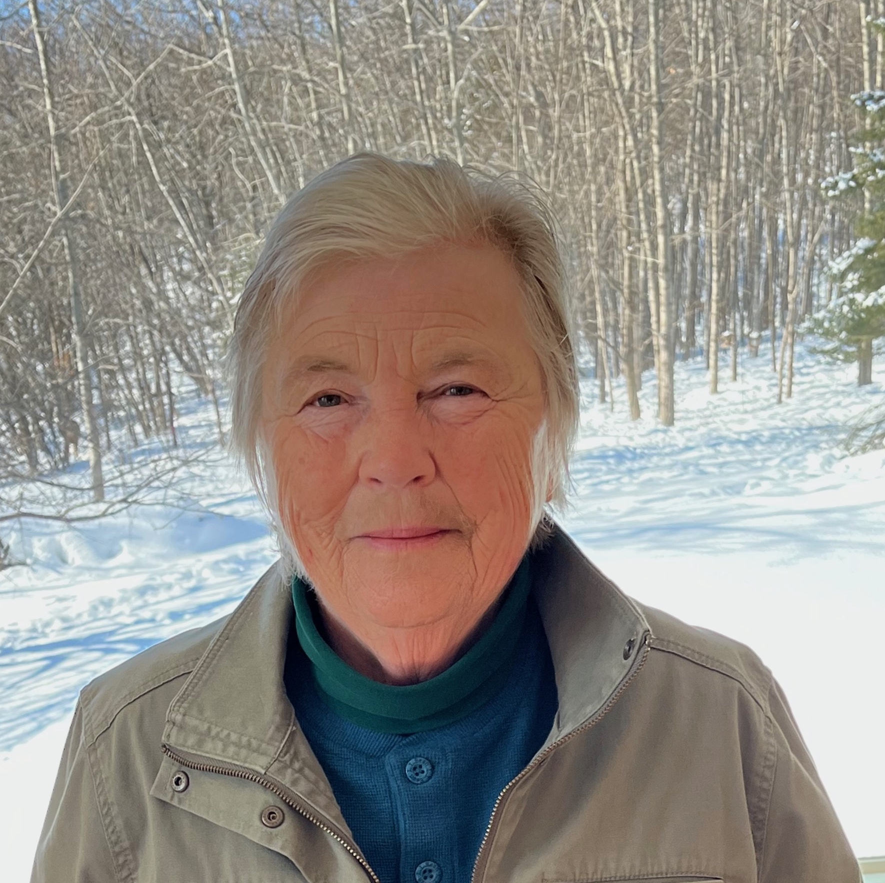 dianna hunter face white woman in front of birch trees in the snow sunny day